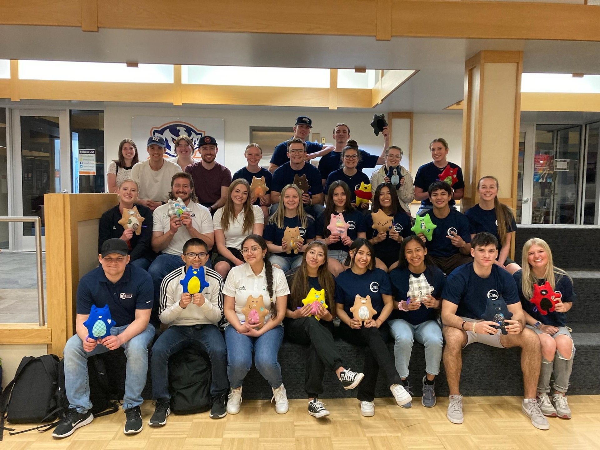 UHS students holding teddy bears for donation.