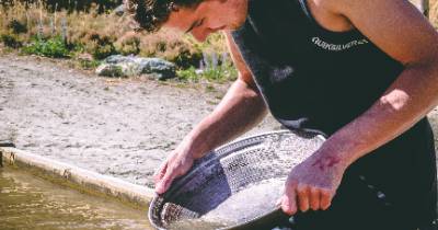 A person panning for gold.