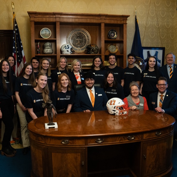 Snow College students and staff surround the Governor's desk