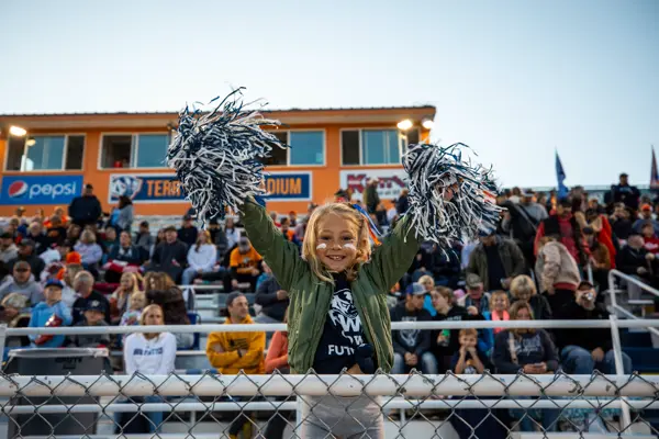 Homecoming crowd and little cheerleader