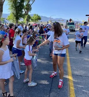 Snow students handing out parade treats