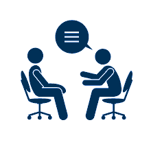Two people sitting in chairs and talking.